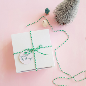 White gift box tied with green bakers twine and a Jessica Kathryn tag. Photo 7