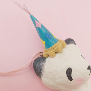Close up photo of spun cotton panda's colourful paper hat with silver tinsil. Photo 3