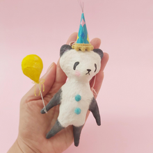 Load image into Gallery viewer, Spun Cotton Panda ornament, holding yellow balloon and wearing a colourful party hat. Held in a hand. Picture 1 
