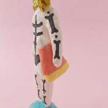 Load image into Gallery viewer, Close up of skeleton holding spun cotton candy corn. Photo 5
