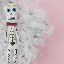 Load image into Gallery viewer, Spun cotton Dia de los Muertos skeleton ornament, laying in box. Photo 1
