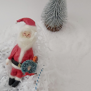 Spun Cotton Santa laying in gift box with white shredded paper. Photo 7 of 7.