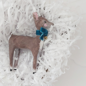 Spun cotton deer laying in white shredded tissue paper. Photo 8 of 8. 