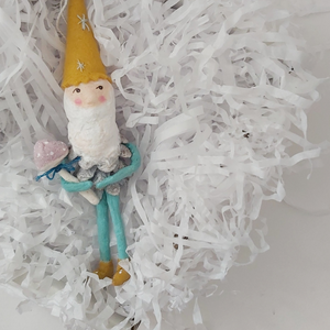 Pine cone gnome, laying in white gift box with white shredded paper. Photo 9 of 9.