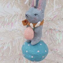 Cargar imagen en el visor de la galería, Close up of spun cotton bunny face and coral pink egg with white flowers. Pic 3 of 8.

