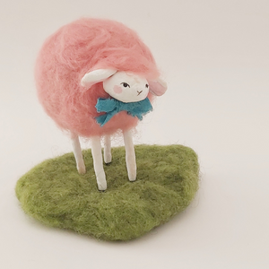 Pink needle felted sheep with blue bow tie, standing on felted green grass. Pic 1 of 6.