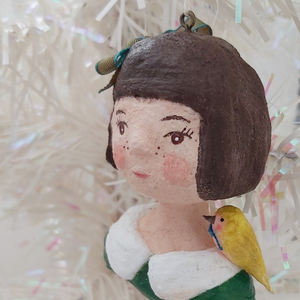 A close side view of spun cotton girl ornament. Pic 5 of 11.