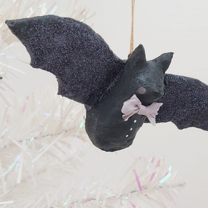 Spun cotton bat ornament, hanging from tree. Pic 1 of 6.