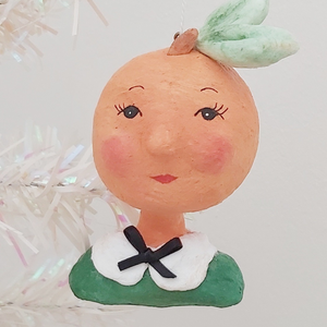 Spun cotton peach girl ornament, hanging from tree.  Pic 2 of 9.