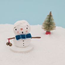 Load image into Gallery viewer, Spun cotton snowman wearing a turquoise velvet bow tie and holding two jingly bells. Pic 1 of 6. 
