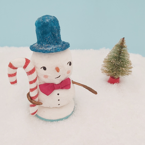 Spun cotton snowman in turquoise top hat, holding candy cane. Pic 8 of 8. 