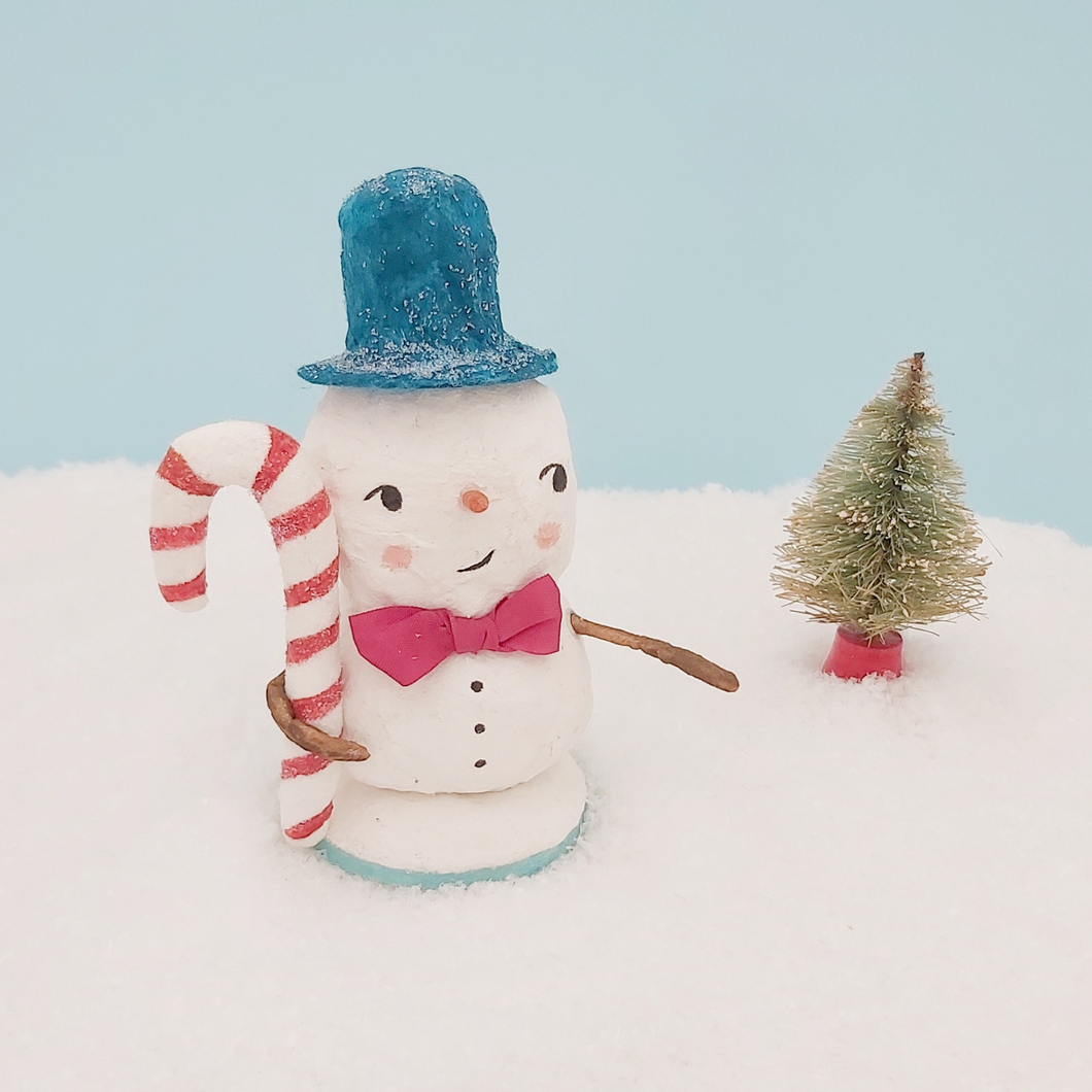 Spun cotton snowman holding spun cotton candy cane. Pic 1 of 8. 