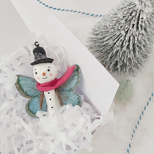 Load image into Gallery viewer, Spun cotton snowman butterfly ornament, laying in white gift box with white tissue shredding. Pic 4 of 5. 
