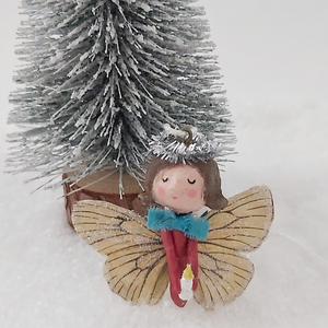 Spun cotton Christmas butterfly angel, standing next to mini Christmas tree. Pic 4 of 6.