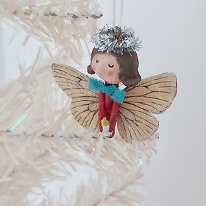 Side view of spun cotton Christmas butterfly angel ornament, dangling on tree. Pic 2 of 6