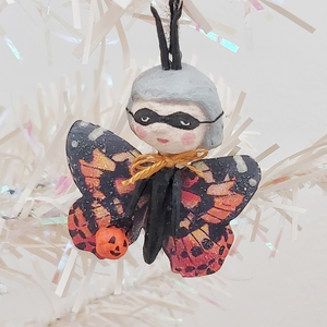 Close up of spun cotton Halloween butterfly ornament, hanging from tree. Pic 2 of 6.