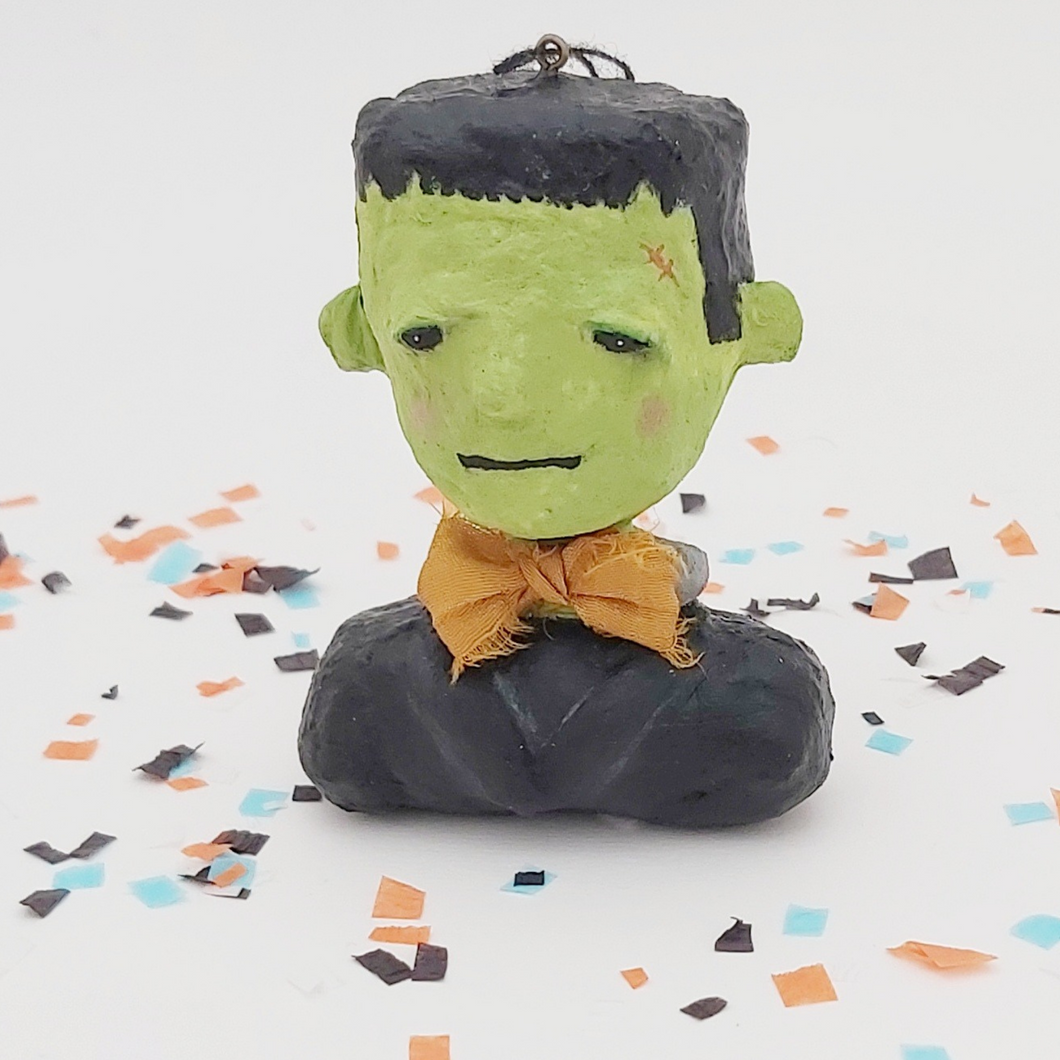Spun cotton Frankenstein Halloween ornament surrounded by Halloween confetti. Pic 1 of 9.