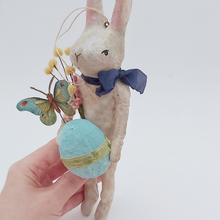 Cargar imagen en el visor de la galería, A hand holding a vintage style spun cotton Easter bunny ornament, against a white background. Pic 9 of 9.
