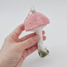 Cargar imagen en el visor de la galería, A hand holding a pink vintage style spun cotton mushroom ornament against a white background. Pic 1 of 4.
