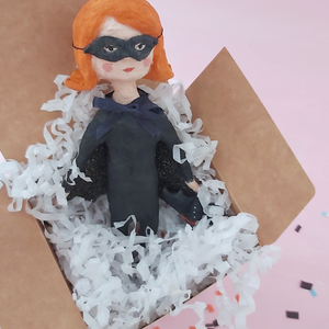 Spun cotton bat girl ornament, standing in white gift box with white tissue shredding. Pic 9 of 9. 