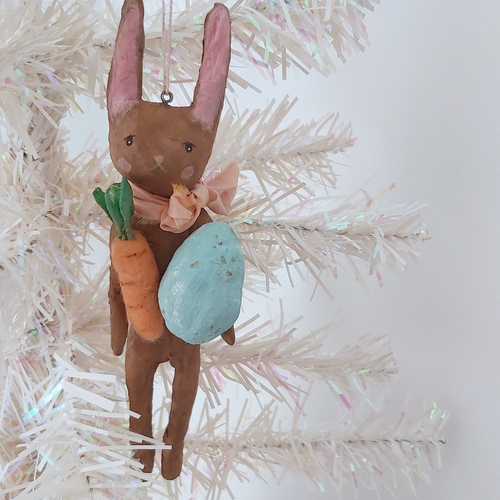 Spun cotton chocolate brown Easter bunny ornament hanging on white tree. Pic 1 of 8.