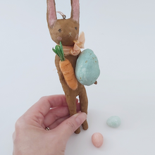 Cargar imagen en el visor de la galería, Spun cotton chocolate brown bunny ornament, held in hand for size comparison. Pic 3 of 8.
