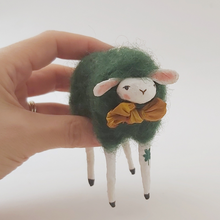 Load image into Gallery viewer, Spun cotton dark green sheep held in hand for size comparison. Pic 2 of 5.
