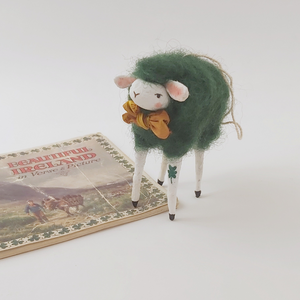 Spun Cotton dark green sheep ornament, standing next to vintage Ireland souvenir book. Pic 1 of 5.
