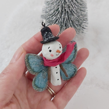 Load image into Gallery viewer, Spun Cotton Snowman Butterfly ornament, held in hand for size comparison. Pic 2 of 5. 

