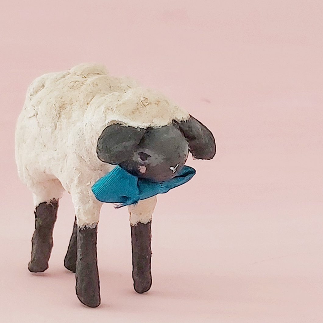 Vintage style miniature spun cotton sheep standing against a pink background. Pic 1 of 8.