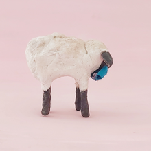 Load image into Gallery viewer, A side view of a vintage style miniature spun cotton sheep, against a pink background. Pic 6 of 8.
