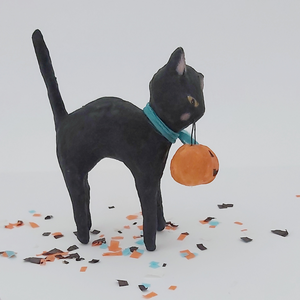 Opposite side view of vintage style spun cotton black cat standing on Halloween confetti against white background. Pic 4 of 6. 