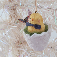 Cargar imagen en el visor de la galería, A vintage style spun cotton chick in a cracked egg ornament, hanging from a white tree. Pic 1 of 6. 
