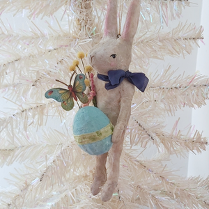 A vintage style spun cotton Easter bunny ornament, hanging on a white tree. Pic 2 of 9.