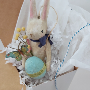 A vintage style spun cotton Easter bunny ornament, standing in a white gift box with white tissue paper against a white background. Pic 8 of 9.