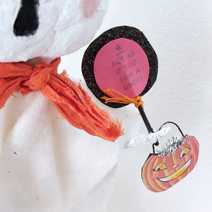 Close up of sign held by spun cotton white jack-o-lantern ghost ornament. Pic 4 of 7.