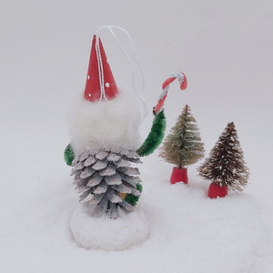 Back view of spun cotton pine cone elf, sitting next to vintage bottle brush trees. Pic 8 of 9. 