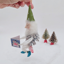 Load image into Gallery viewer, Opposite side view of vintage style spun cotton pine cone elf sitting on a spun cotton candy cane. Pic 6 of 10. 
