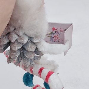 Close up view of inside of vintage style snowman Christmas card held by pine cone elf. Pic 9 of 10. 
