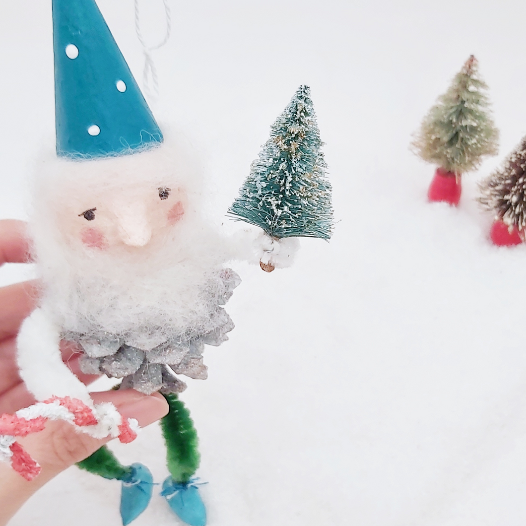 Close up of spun cotton pine cone elf's face and bottle brush tree. Pic 1 of 7.