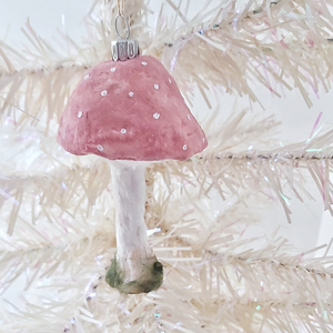 A vintage style spun cotton pink mushroom ornament, hanging on a white tree. Pic 2 of 4.