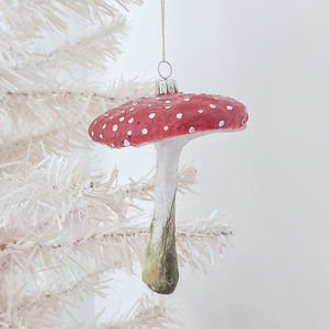 A vintage style spun cotton red mushroom ornament, hanging on a white tree. Pic 2 of 5. 