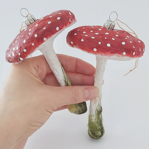 Vintage style spun cotton red mushrooms, held in hand against a white backdrop. Pic 1 of 5. 