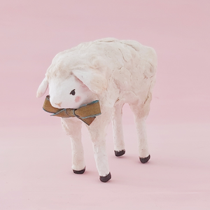 A front side view of a spun cotton sheep against a pink background. Pic 5 of 8.