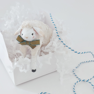 A spun cotton sheep hanging out of a white gift box against a white background. Pic 4 of 8.