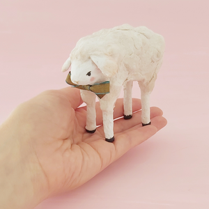 A vintage style spun cotton sheep, held in hand against a pink background. Pic 2 of 8.