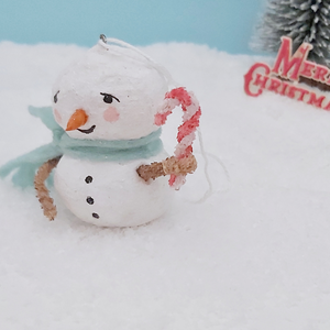 A closer view of vintage style spun cotton snowman's pipe cleaner candy cane. He's standing on fake snow. Pic 5 of 7.