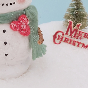 Close-up of the glittered red pom-pom berries that the spun cotton snowman is wearing. Pic 5 of 7.