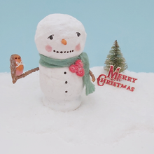 Cargar imagen en el visor de la galería, Vintage style spun cotton snowman holding a spun cotton robin on his arm. He sits on snow, against a light blue background and in front of a vintage bottle brush tree and Merry Christmas sign. Pic 1 of 7.
