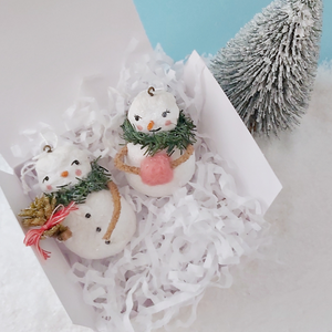 Vintage style spun cotton snowman and snow lady ornaments laying in white gift box on white tissue shredding. Pic 11 of 11.